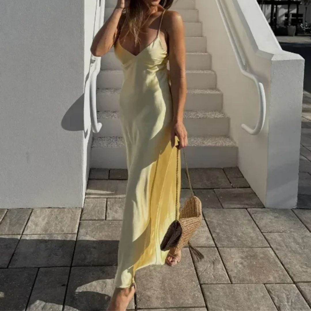 Woman wearing champagne satin slip dress with side slit