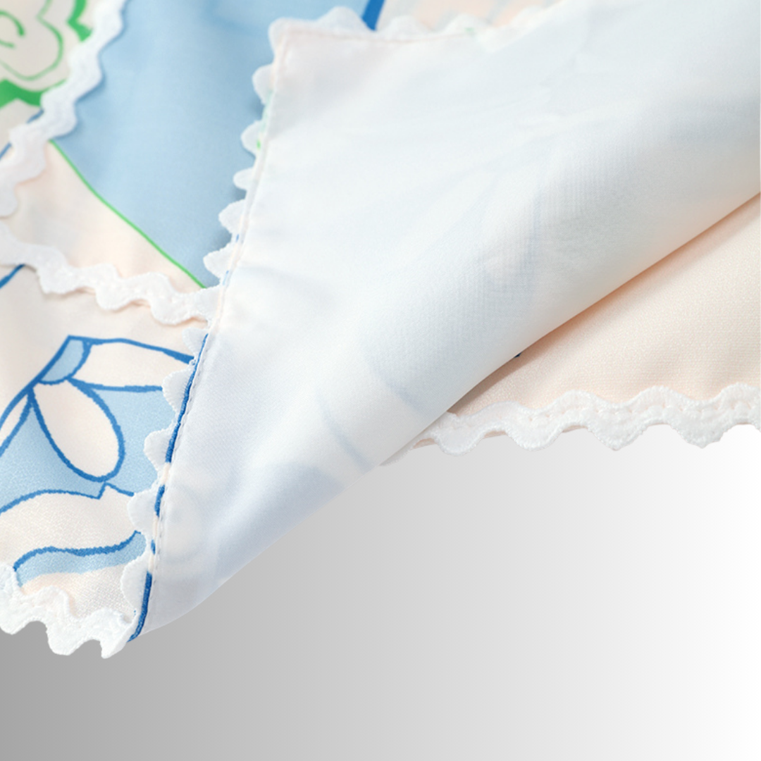 Woman wearing the Ariella coordinating set: a Mediterranean print shirt and matching high-waisted shorts_zoom in on the fabric details