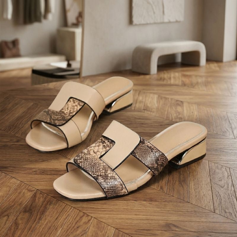 Close-up texture detail of beige snake print women’s sandals