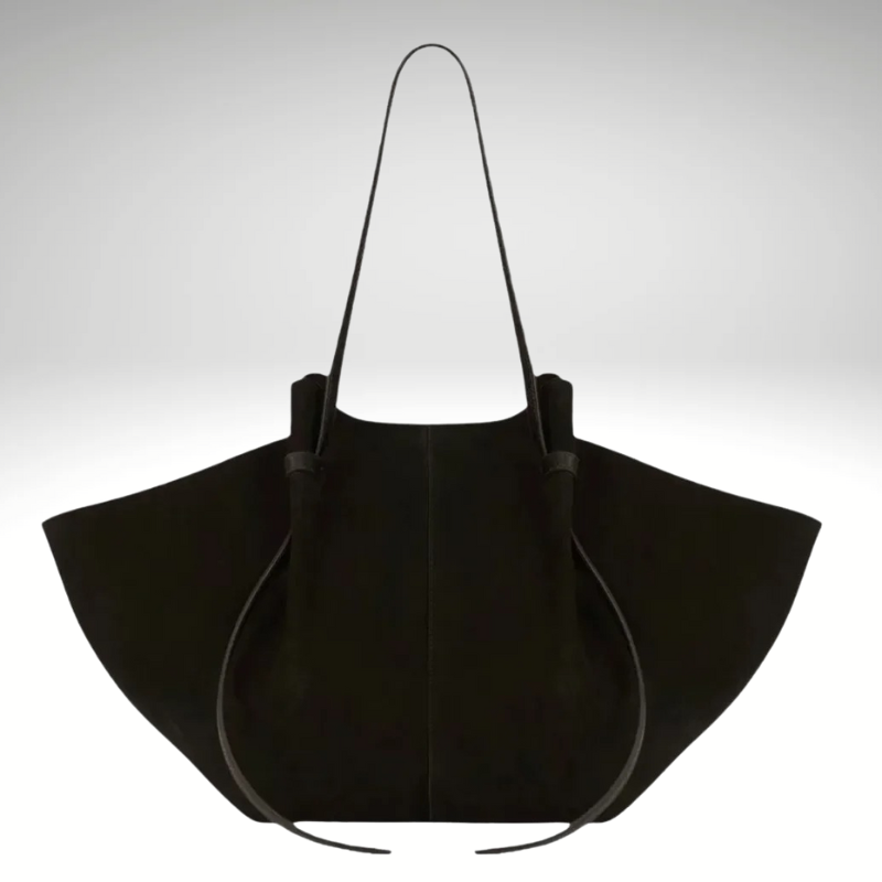 Black faux suede women’s tote bag worn on shoulder