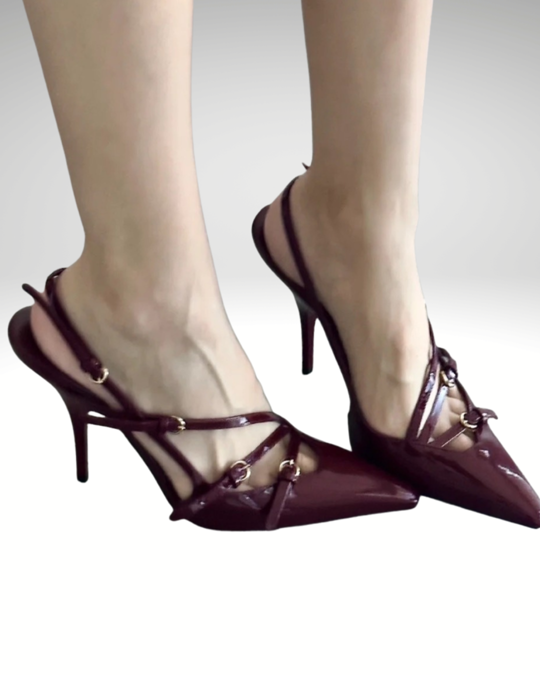 Close-up of burgundy patent leather pointed toe heels showing glossy finish