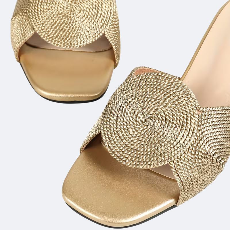 Detailed view of breathable knit fabric with gold thread on comfortable high heel shoes for women