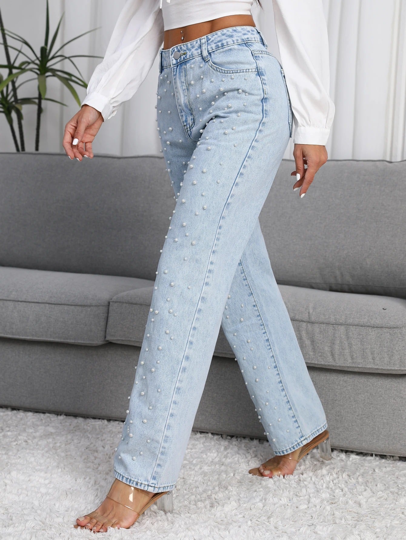 Close-up of pearl details on women’s straight-leg jeans