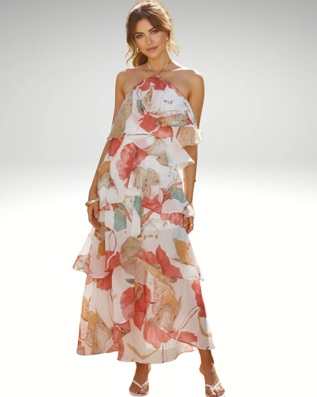 Front view of woman wearing floral halter neck maxi dress with ruffles