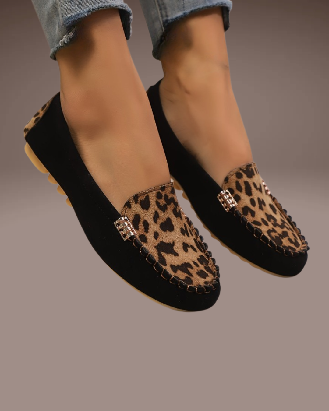 Close-up of the leopard pattern and gold ornaments – moccasin-style stitching and soft suede texture