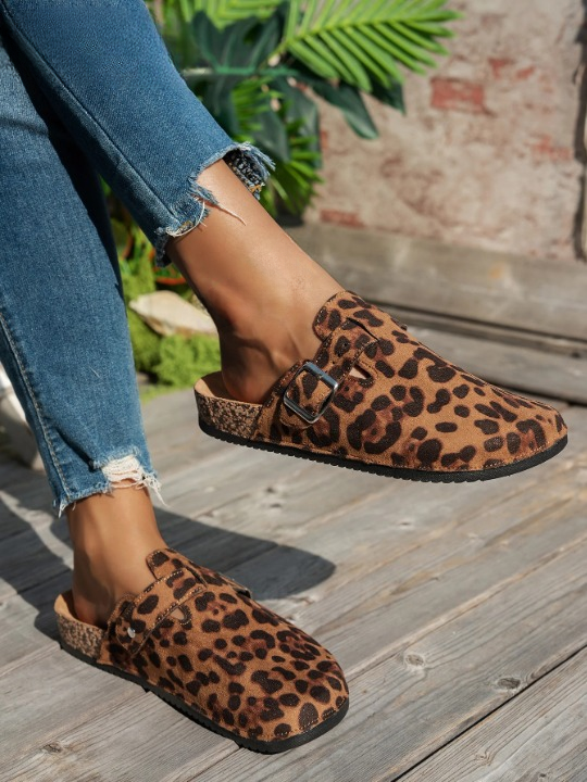 Women wearing leopard print mules with frayed denim jeans