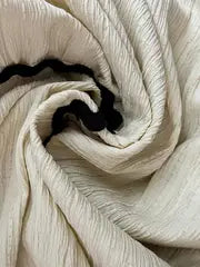 Close-up of Malia Set's smocked strapless crop top in cream with wavy black edging