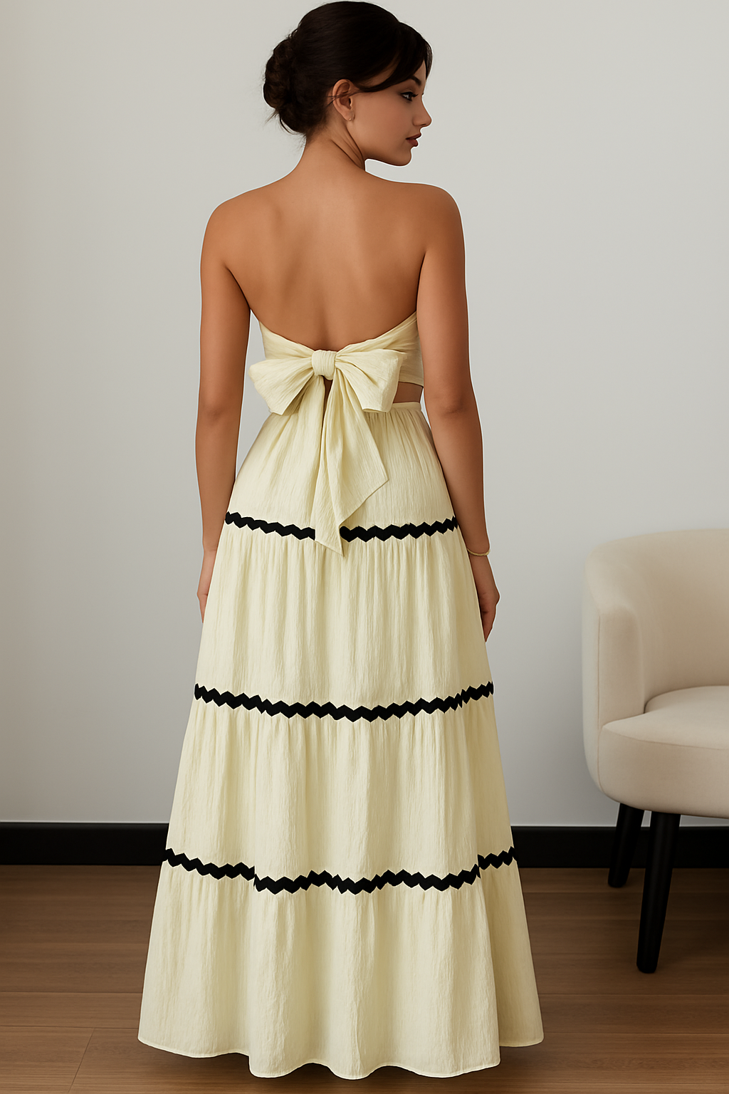 Detail of Malia’s high-waisted tiered maxi skirt with black contrast trim