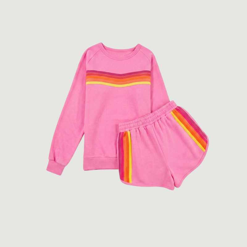 Close-up detail of colorful contrast stripes on pink oversized women’s sweatshirt