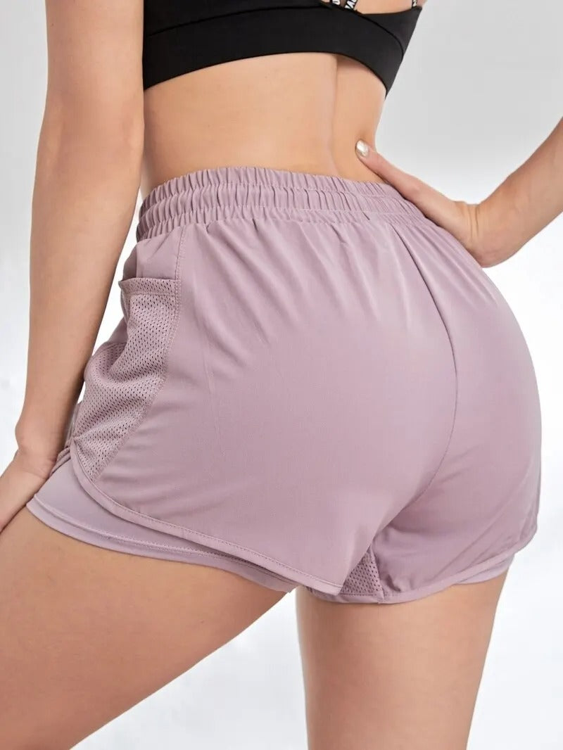 purple women’s sports shorts with pockets and integrated leggings