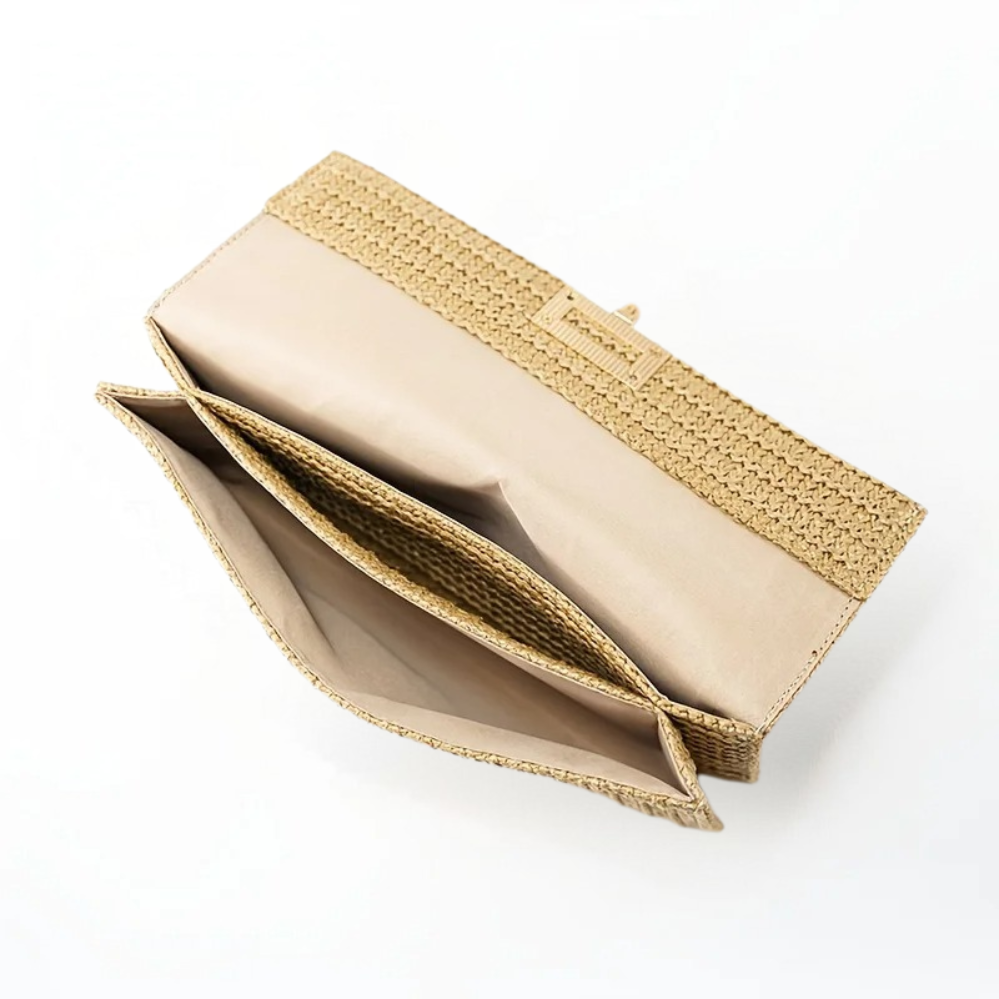Close-up detail of the elegant gold buckle on the Raya woven clutch