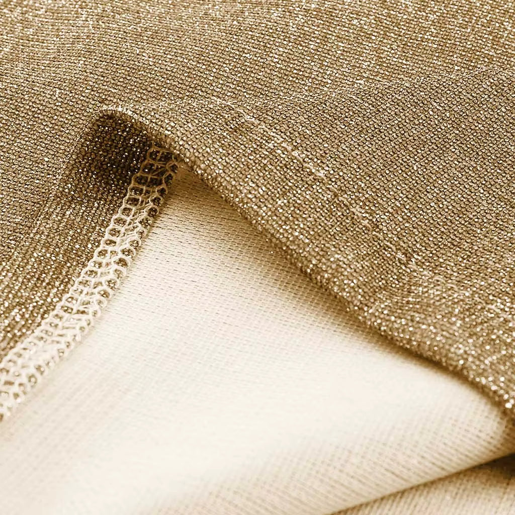 Close-up detail of sparkling sequins on women’s shiny top -gold