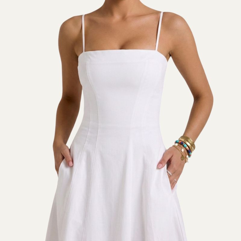 Close-up of square neckline on elegant white midi dress for women