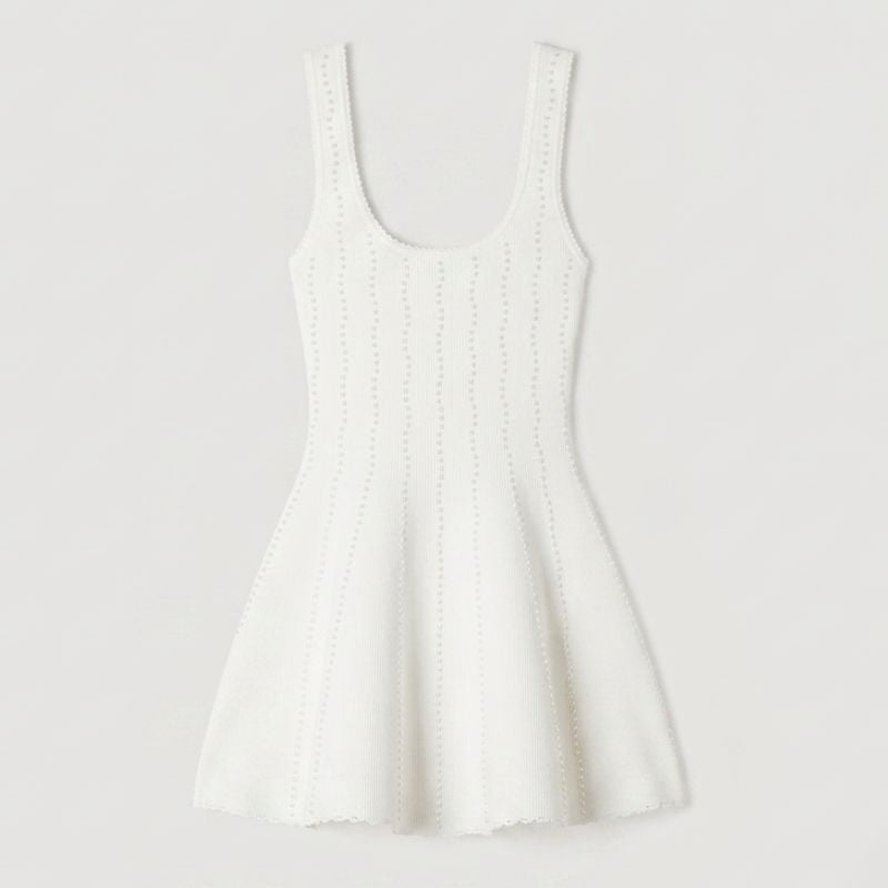 Close-up of delicate bead embellishments on women’s knitted summer dress fabric