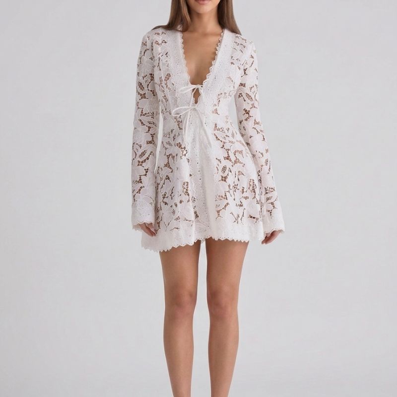 Front view of a women's white boho lace mini dress featuring long sleeves and a deep V-neck
