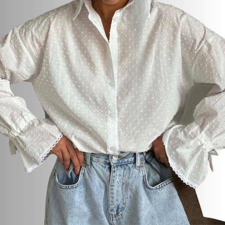 Front view of white cotton blouse with trumpet sleeves