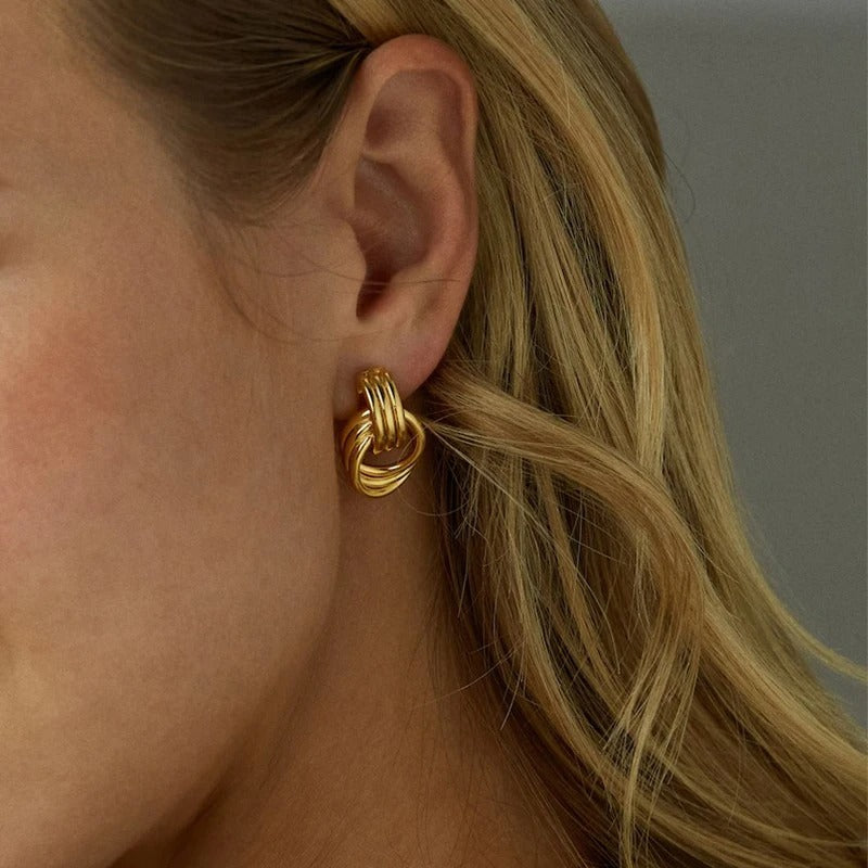 Elegant woman wearing vintage gold geometric multilayer earrings, timeless and chic jewelry accessory