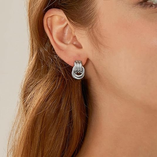 Stylish woman wearing vintage silver multilayer earrings, modern and elegant fashion jewelry