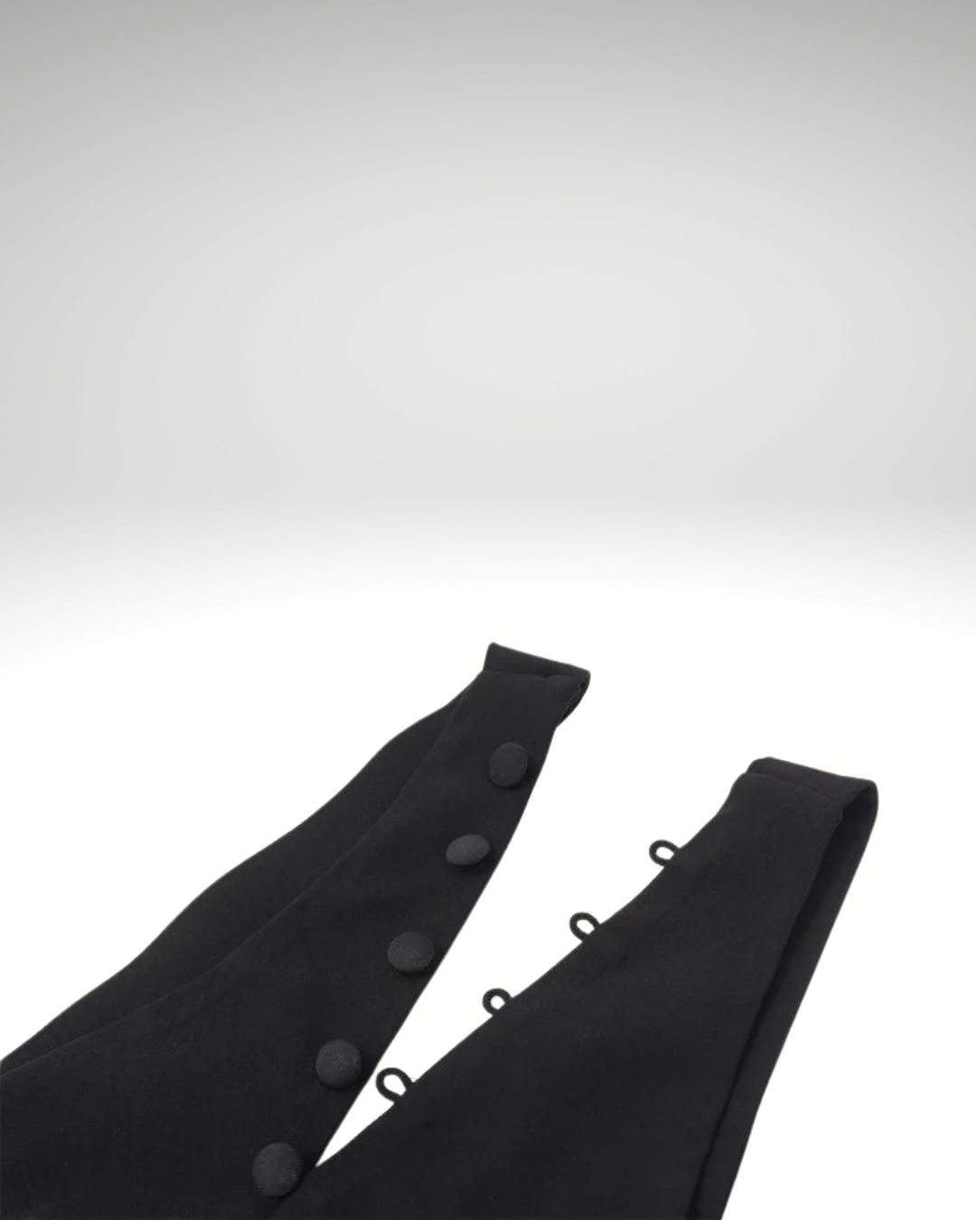 Close-up detail of black asymmetrical women’s sleeveless vest fabric and button fastening