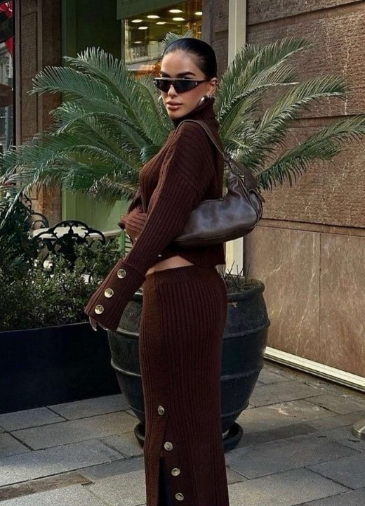Back view of women’s brown knitted turtleneck set with long skirt.