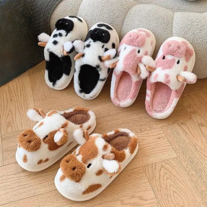 Women’s cow plush slippers in black, pink, and brown – warm fuzzy indoor shoes for winter, thick sole and soft plush lining, cute animal design.