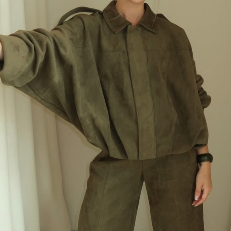 Lifestyle photo of women’s green suede bomber jacket