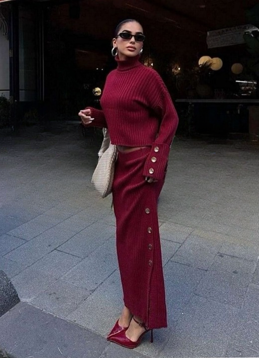 Side profile of women’s red knitted set with slit skirt and turtleneck