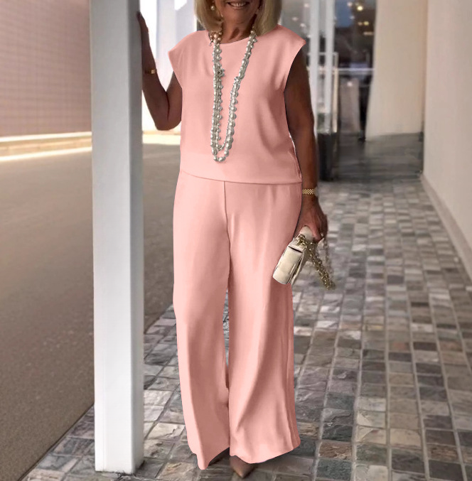 Pink women’s chic two-piece outfit – sleeveless top with flowy high-waist pants.