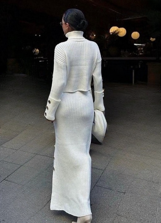 Back view of women’s white knitted turtleneck set with long skirt