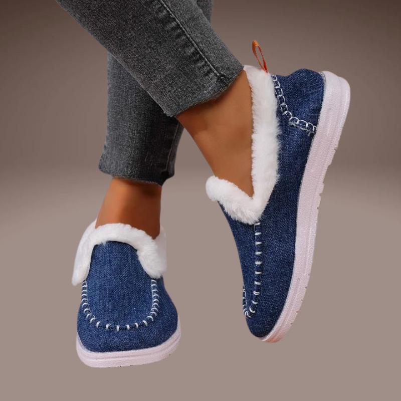 denim blue women’s winter slippers worn in the snow