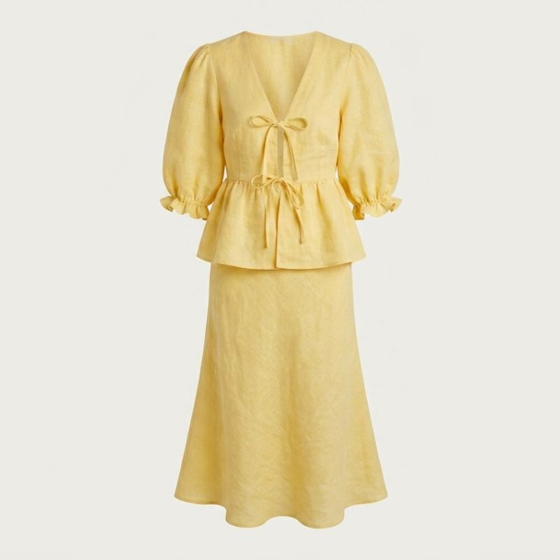close up of yellow two piece set showing lace up v neck detail and fabric texture